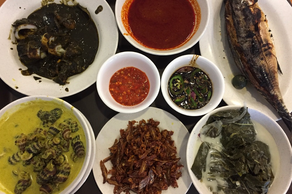 A table full of authentic Malay dishes prepared by Hajah Maimunah, a popular restaurant in Singapore